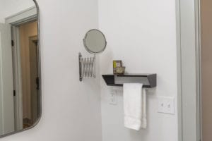 Wall mount extendable mirror, shelf and towel rack.