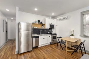 Kitchen with stainless stell appliances and hardwood floors.